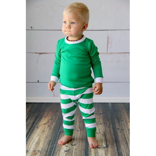 little boy wearing green and white striped pajamas